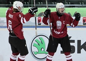 ZUG, SWITZERLAND - APRIL 16: Latvia's Kristaps Zile #7 celebrates with Karlis Cukste #6 after a first period goal against Canada during preliminary round action at the 2015 IIHF Ice Hockey U18 World Championship. (Photo by Francois Laplante/HHOF-IIHF Images)